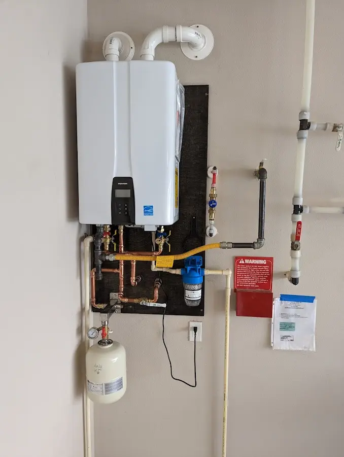 Professional plumber installing copper piping in a Brady home